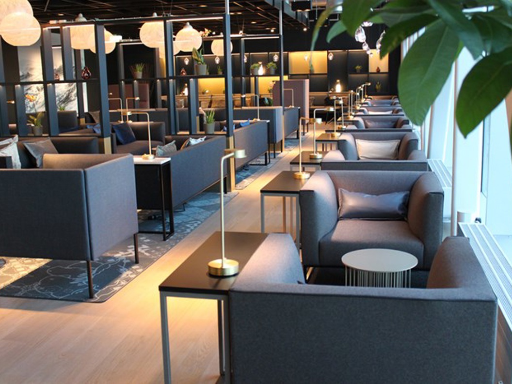 Modern airport lounge with elegant seating, ambient lighting, and contemporary decor, creating a comfortable and stylish environment for travelers