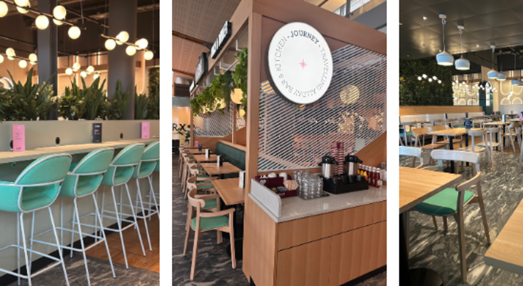 Kaféinteriør med grøne planter, moderne innreiing og sitjeplassar. Skilt for "Coffee & Breakfast" og "Lunch & Dinner" visast. Lyse og innbydande rom med stolrader ved disken og spisebord