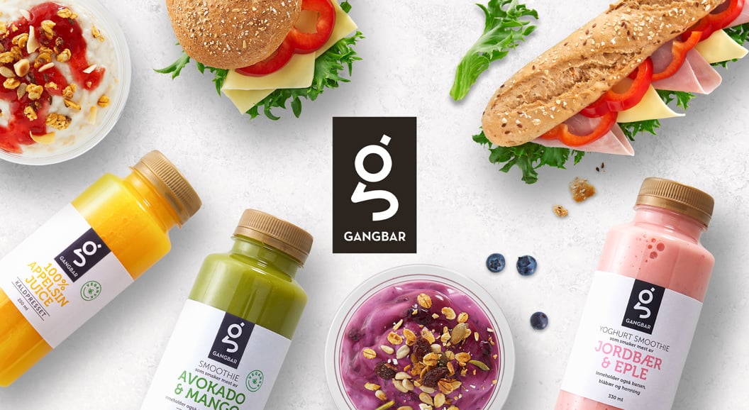 Gangbar food and drink assortment featuring smoothies, juices, yogurt cups, sandwiches, and burgers with fresh ingredients displayed on a white background