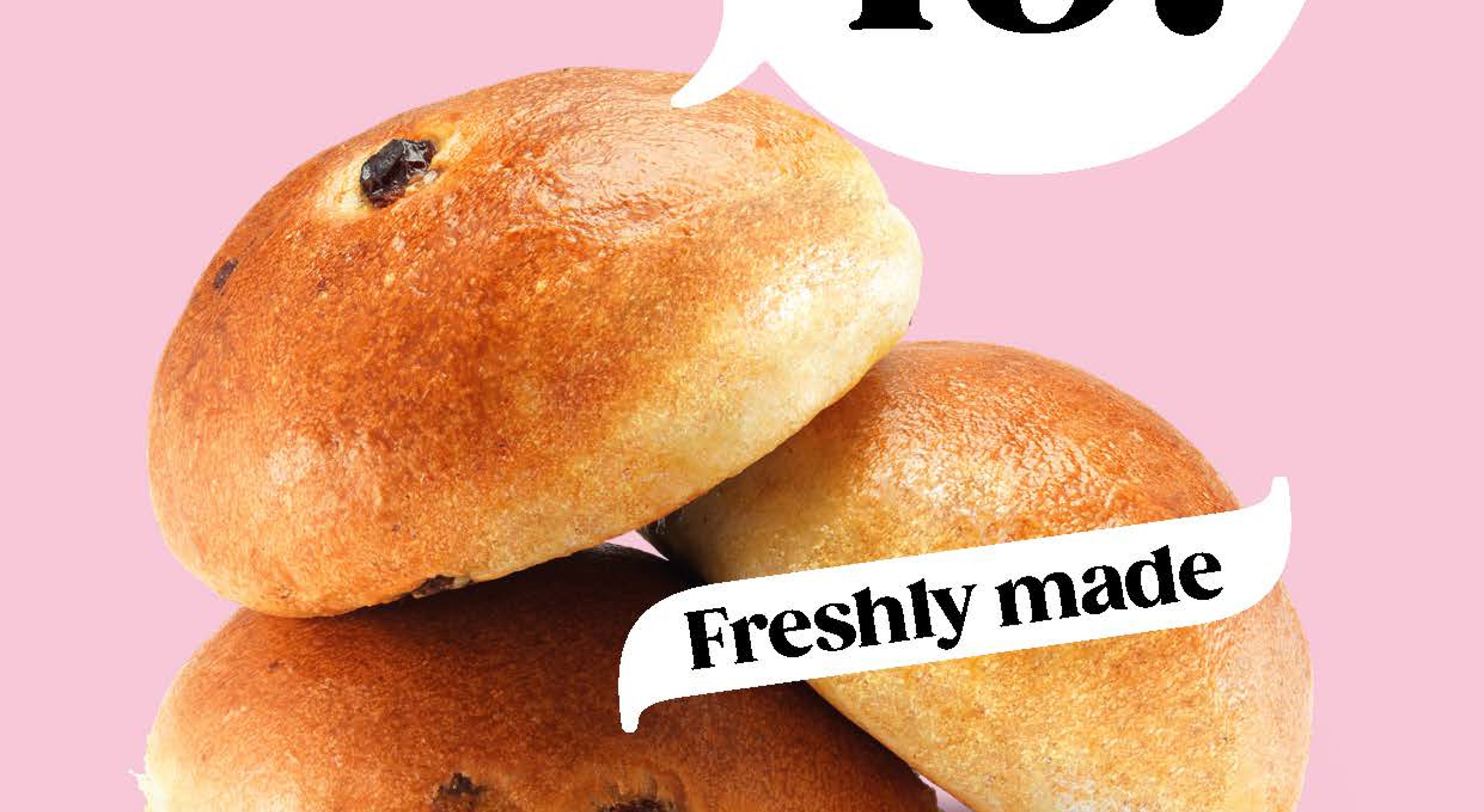 Freshly baked wheat, raisin, and chocolate buns on a pink background with a price promotion of three for 49