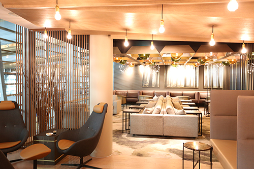Moderne lounge med stilfull innredning, komfortable sitteplasser, dempet belysning og dekorative elementer.