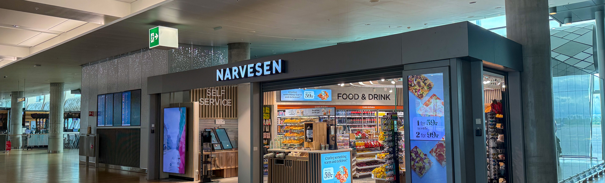 Narvesen convenience store in an airport terminal with food and drink displays and self-service kiosk