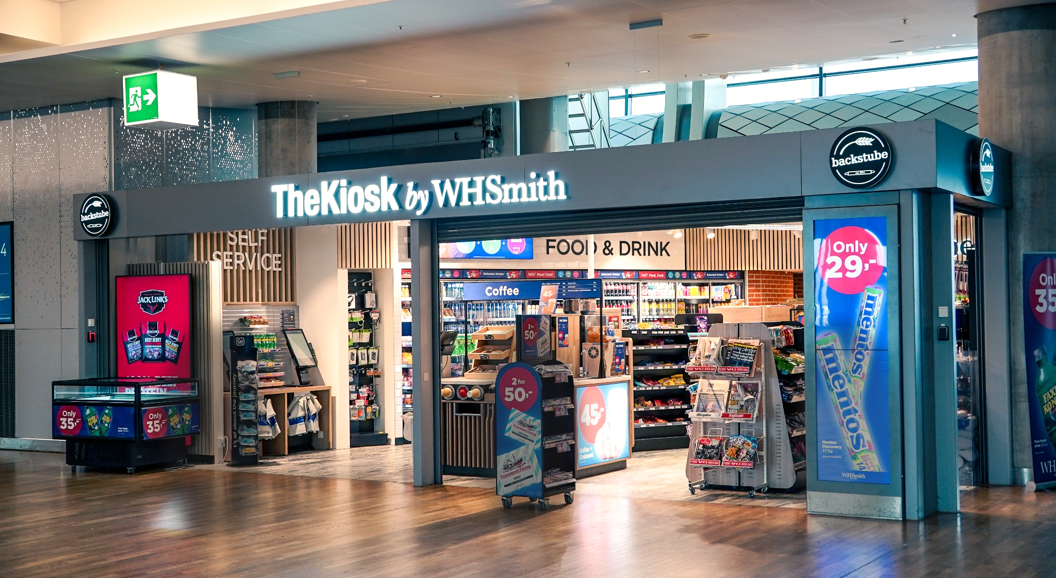 The Kiosk by WHSmith at an airport, featuring a selection of food, drinks, and magazines