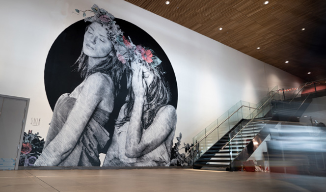 Artwork at Stavanger Airport, painting on a large wall of two women
