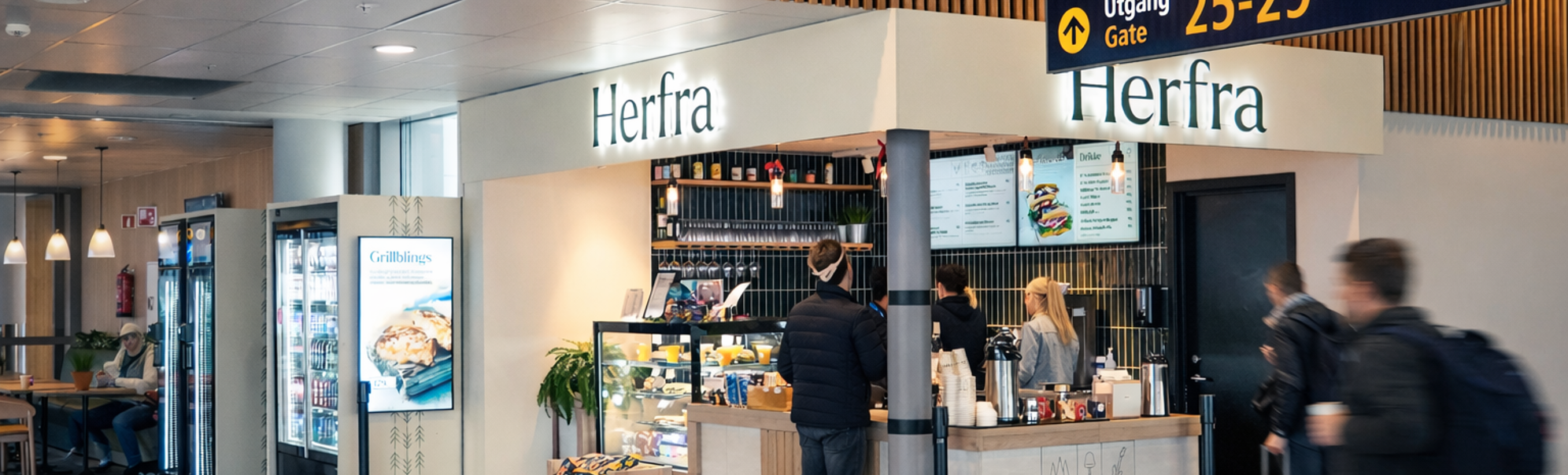 Airport café and snack bar named Herfra near Gate 25-29, with travelers and luggage in a terminal hallway